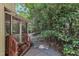 Beautiful backyard featuring a screened-in porch, lush trees and landscaping at 100 Windvale Ct, Cary, NC 27518