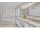 Bright bathroom boasts a soaking tub, a double sink vanity and a glass shower at 100 Windvale Ct, Cary, NC 27518