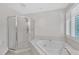 Bathroom featuring a soaking tub and glass shower at 100 Windvale Ct, Cary, NC 27518