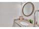 Bathroom vanity with granite countertop, oval mirror, and decorative accessories at 100 Windvale Ct, Cary, NC 27518