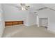 Bright bedroom featuring neutral carpet, a ceiling fan, and built-in wooden shelving at 100 Windvale Ct, Cary, NC 27518