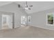 Spacious bedroom with vaulted ceiling, ceiling fan, and multiple windows at 100 Windvale Ct, Cary, NC 27518