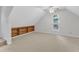 Bonus room with built-in shelves, carpet, and an arched window at 100 Windvale Ct, Cary, NC 27518