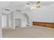 Bonus room features built-in shelves, neutral carpet, and ceiling fan at 100 Windvale Ct, Cary, NC 27518