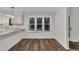 Bright dining area with wood floors, white wainscoting, and a large window overlooking the yard at 100 Windvale Ct, Cary, NC 27518