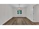 Open dining room with wood-look floors and decorative chandelier at 100 Windvale Ct, Cary, NC 27518