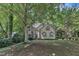 Traditional home with mature trees providing shade, offering a serene and private setting at 100 Windvale Ct, Cary, NC 27518