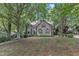 Inviting home with manicured lawn, mature trees, and a quaint, traditional facade at 100 Windvale Ct, Cary, NC 27518