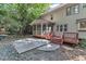 Back exterior of home featuring a screened in porch, deck, and a patio at 100 Windvale Ct, Cary, NC 27518