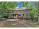 Back exterior of home featuring a screened in porch, deck, and a patio at 100 Windvale Ct, Cary, NC 27518