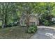 Charming two-story home with an attached two-car garage nestled among mature trees on a lush lot at 100 Windvale Ct, Cary, NC 27518