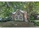 Well-maintained home with mature trees, flag, and traditional architectural details at 100 Windvale Ct, Cary, NC 27518