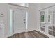 Bright foyer featuring a white front door with sidelights and elegant french doors leading to another room at 100 Windvale Ct, Cary, NC 27518