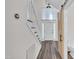 Spacious foyer featuring a staircase, light-filled entry, and a charming barn door to the restroom at 100 Windvale Ct, Cary, NC 27518