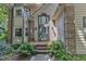 Welcoming front entrance featuring brick steps, transom window and lush greenery at 100 Windvale Ct, Cary, NC 27518