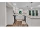 Beautiful kitchen boasts white cabinetry, modern appliances, and granite countertops at 100 Windvale Ct, Cary, NC 27518
