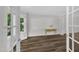 Living room showcasing hardwood floors, a bay window, neutral paint, and french doors at 100 Windvale Ct, Cary, NC 27518