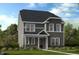 Beautiful two-story home showcasing a dark gray roof, gray siding, and white trimmed windows at 1057 Hardin Hill Ln, Knightdale, NC 27545