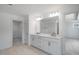 Well-lit bathroom featuring a double sink vanity, large mirror, and an adjacent room perfect for storage at 1061 Hardin Hill Ln, Knightdale, NC 27545