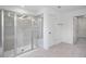 Bright bathroom with a glass-enclosed shower, neutral tile, and a view into the spacious walk-in closet at 1061 Hardin Hill Ln, Knightdale, NC 27545