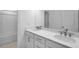 Modern bathroom featuring double sinks, quartz countertops, sleek hardware, and a shower/tub combination at 1061 Hardin Hill Ln, Knightdale, NC 27545