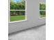 Bright bedroom with neutral carpet and walls, featuring a lovely view of the backyard at 1061 Hardin Hill Ln, Knightdale, NC 27545