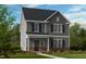 Charming two-story home with gray siding, black shutters, and a brick foundation at 1061 Hardin Hill Ln, Knightdale, NC 27545