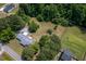 Aerial view of a home with mature trees and a long driveway at 1067 Thompson Rd, Four Oaks, NC 27524