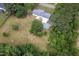 Aerial view of a well-maintained home with mature trees, and a spacious lot at 1067 Thompson Rd, Four Oaks, NC 27524