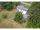 Aerial view of a home with mature trees, a long driveway, and a spacious lot at 1067 Thompson Rd, Four Oaks, NC 27524