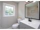 Updated bathroom featuring tiled shower, sleek vanity and new light fixture at 1067 Thompson Rd, Four Oaks, NC 27524