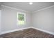 Bright bedroom with wood floors, neutral paint, and double-hung windows at 1067 Thompson Rd, Four Oaks, NC 27524