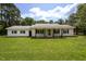 Charming single-story brick home with a welcoming front porch and a well-manicured lawn at 1067 Thompson Rd, Four Oaks, NC 27524