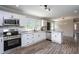 Updated kitchen featuring white cabinets, granite counters, stainless steel appliances, and an island at 1067 Thompson Rd, Four Oaks, NC 27524