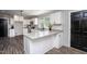 Bright kitchen featuring white cabinets, granite countertops, stainless steel appliances, and a black door at 1067 Thompson Rd, Four Oaks, NC 27524