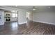 Spacious living room with wood-look floors, ceiling fan, and open access to kitchen at 1067 Thompson Rd, Four Oaks, NC 27524