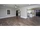 Open-concept living room featuring wood-look floors, a ceiling fan, and gray walls at 1067 Thompson Rd, Four Oaks, NC 27524
