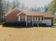 Charming brick home featuring an attached garage and well-manicured lawn at 1098 Blackstone Dr, Creedmoor, NC 27522