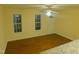 Cozy living space featuring wood floors, ceiling fan, natural light, and access to kitchen at 1098 Blackstone Dr, Creedmoor, NC 27522