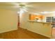 Bright living space featuring hardwood floors, ceiling fan, and breakfast bar to kitchen at 1098 Blackstone Dr, Creedmoor, NC 27522