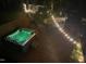 Backyard deck at night featuring a hot tub with lights and string lights creating a relaxing ambiance at 1139 Princeton Kenly Rd, Kenly, NC 27542