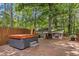 Backyard deck featuring a hot tub, wooden fence, and a tranquil wooded setting at 1139 Princeton Kenly Rd, Kenly, NC 27542
