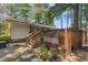 Backyard deck featuring a hot tub, wooden railing, and a tranquil wooded setting at 1139 Princeton Kenly Rd, Kenly, NC 27542