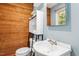 Bathroom features a toilet, sink, mirror, wood accents, and modern fixtures at 1139 Princeton Kenly Rd, Kenly, NC 27542