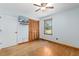 A bedroom with hardwood floors, a ceiling fan, and a wooden closet at 1139 Princeton Kenly Rd, Kenly, NC 27542