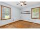 An empty bedroom features hardwood floors, two windows, and minimalist decor at 1139 Princeton Kenly Rd, Kenly, NC 27542