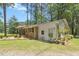 Well-manicured lawn and brick exterior home with a small white addition at 1139 Princeton Kenly Rd, Kenly, NC 27542