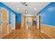 Spacious hallway with hardwood floors and bright blue walls at 1139 Princeton Kenly Rd, Kenly, NC 27542