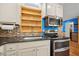 A kitchen with stainless steel appliances, including a microwave and oven, and light-colored cabinets at 1139 Princeton Kenly Rd, Kenly, NC 27542