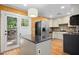 Kitchen with stainless steel appliances, a black countertop island, and access to the outdoor deck at 1139 Princeton Kenly Rd, Kenly, NC 27542